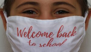 Child with a mask for back to school health: acupuncture & naturopath medicine